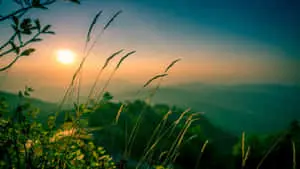 A serene landscape with rolling hills and gorgeous sunset
