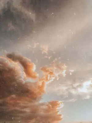 a sunset with clouds and stars in the sky