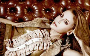 American Actress Alyssa Milano Lying On A Couch