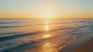 Breathtaking Ocean Sunset with Golden Reflections on Gentle Waves and a Serene Beach Horizon  
