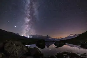 the milky above a lake and mountains