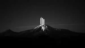 a black and white photo of a mountain with a mountain logo