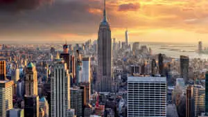 a cityscape with buildings and a sunset