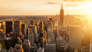 a cityscape with a sun setting over it