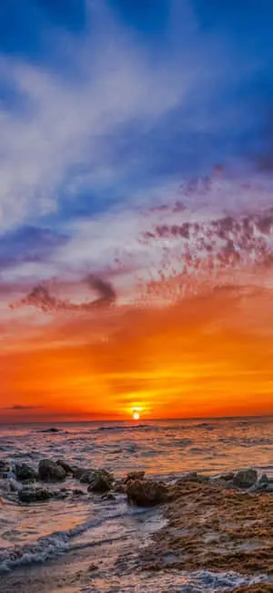 "Vibrant iphone X wallpaper capturing an idyllic day at the beach"